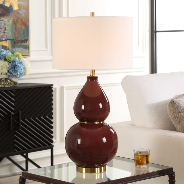 This Timeless Gourd Shaped Ceramic Base Is Finished In A Deep Burgundy Glaze Accented With Lightly Antiqued Brass Plated...