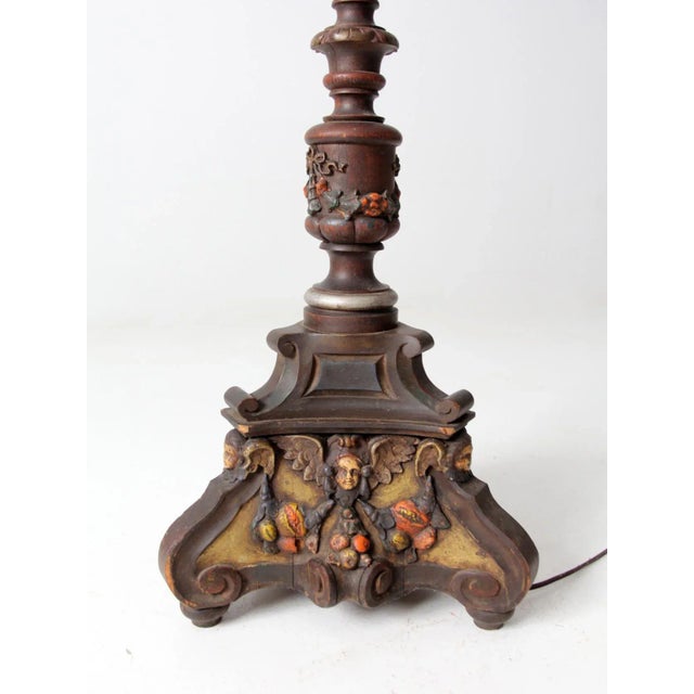 A rare antique carved wood floor lamp featuring an ornate three-quarter form and a richly detailed sculptural base. The...