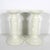 Pair of creamy white porcelain candleholders. These have a beaded rim and raised fruit detail. They hold a standard taper...