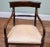 Attractive pair of Regency style mahogany chairs comprising one armchair and one side chair. Broad figured top rails are...