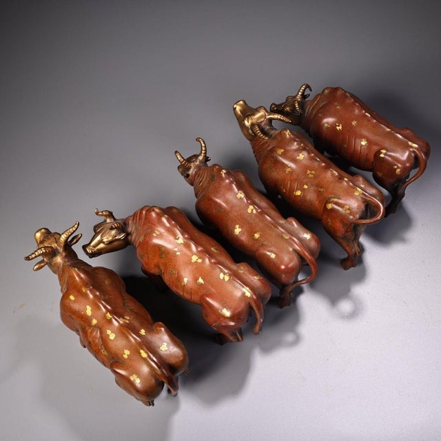 This charming set comprises five figures of oxen, traditional symbols of strength, diligence, and agricultural prosperity....