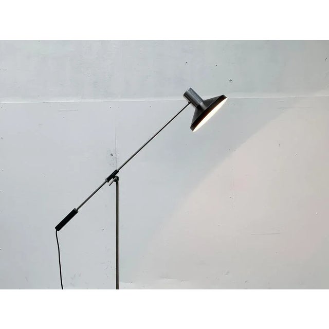 Minimalist Mid Century floor lamp. A simple design in a minimalist design language. The lamp head features a classic shape...