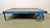 Former pallet truck from a factory now serves as a coffee table. It features a blue iron construction with two original...