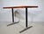 Teak desk or dining table from the 1960s with a rectangular, restored teak top and a black metal frame with aluminum-...
