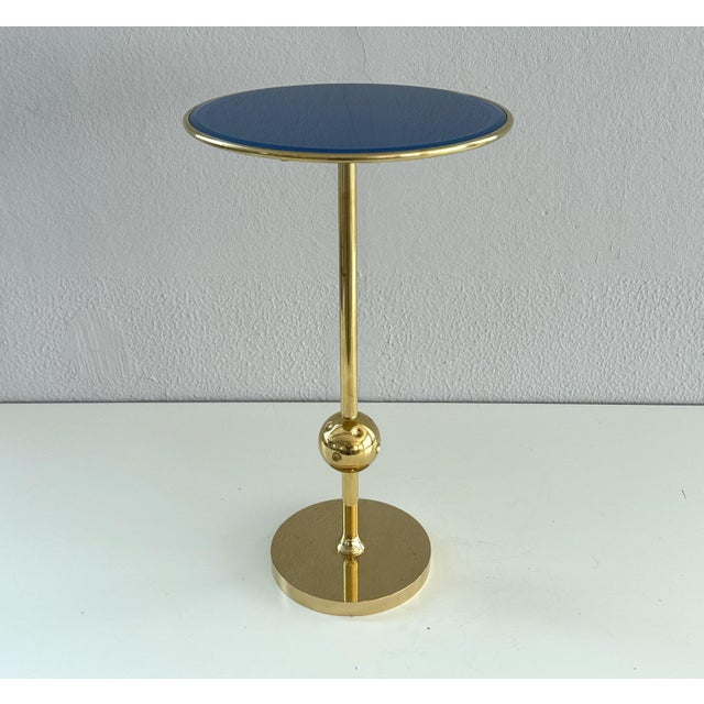 Iconic side table Mod. T1, made of full brass and painted glass top in blue color. Designed in the 1950s by Osvaldo...