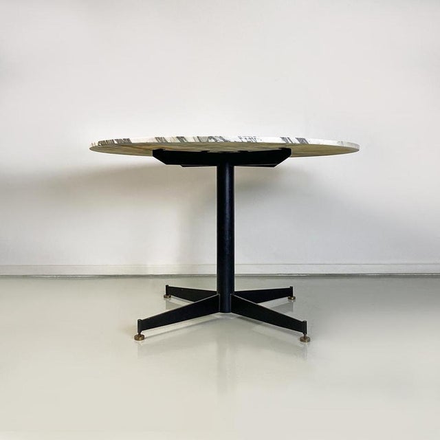 Italian Mid-Century Modern round grey and white marble, black metal and brass details dining table, 1950s. Dining table...