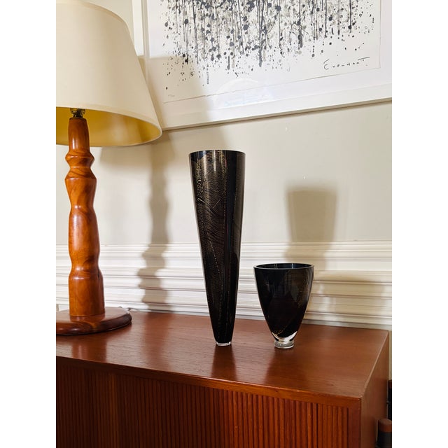 A striking coordinating pair of vintage black and gold art glass vases, attributed to the renowned Theresienthal...