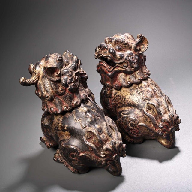 This is a matching pair of cast bronze incense burners (censers) in the form of seated guardian lions (Foo Dogs). Both...