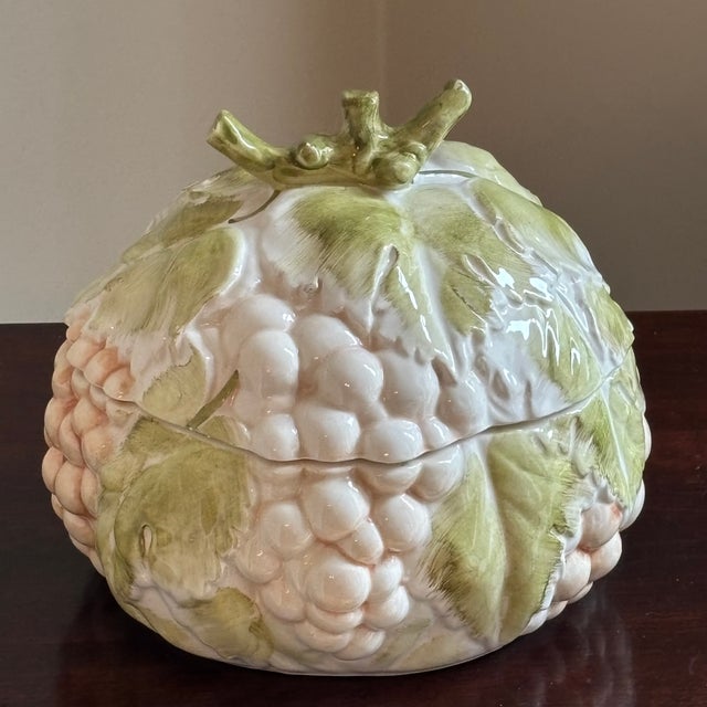 A delightful vintage Italian majolica covered soup tureen sculpted as a lush cluster of ripened grapes entwined with...