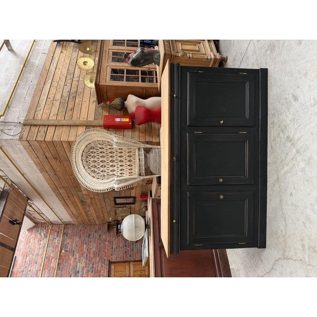 This antique cherry wood sideboard has been fully restored. It features a black patinated base with three functional...