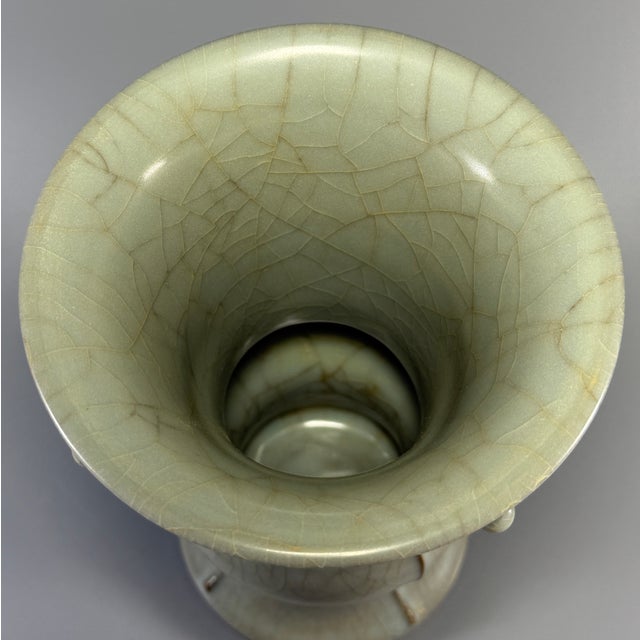 Fine antique Chinese celadon gu‑form beaker vase. Flaring wide rim with vertical raised flanges, segmented bulbous body,...