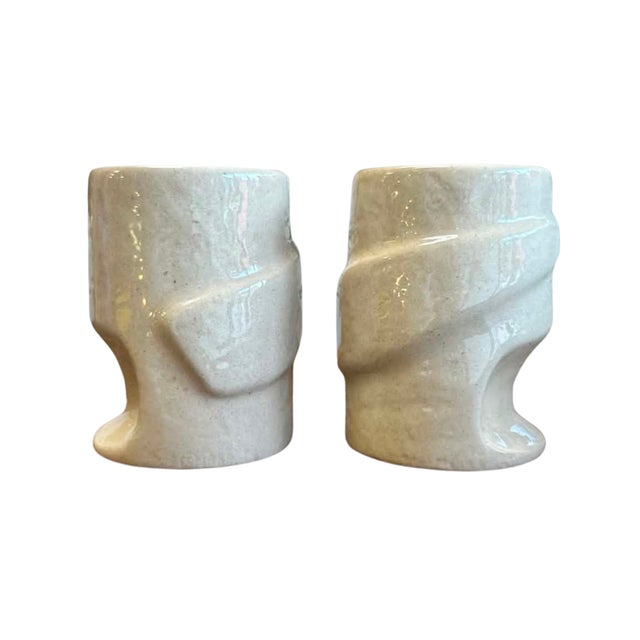 A striking pair of vintage studio pottery mugs distinguished by their sculptural, hand-formed silhouettes and soft...