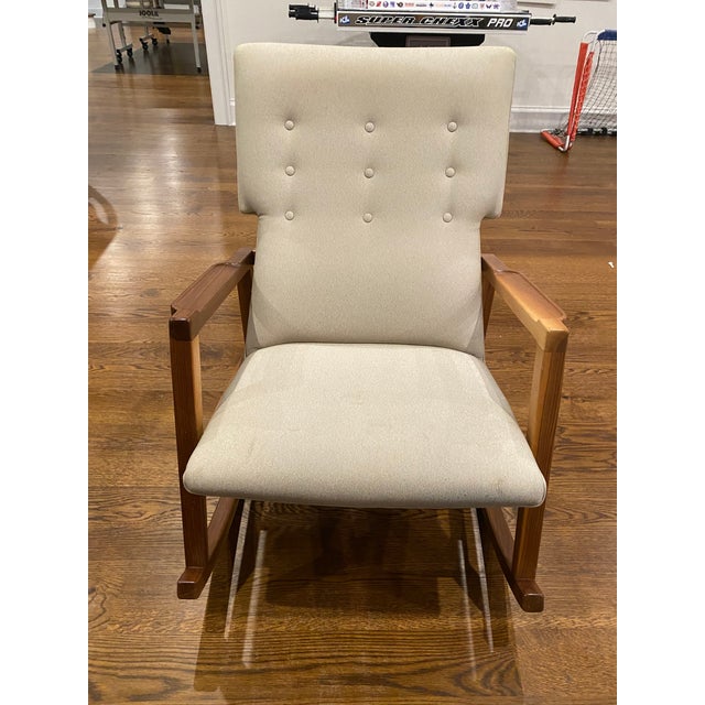 Solid walnut frame. Hidden counterweight provides a smooth, balanced feeling. Nine-button tufted back. Wear on the hind...