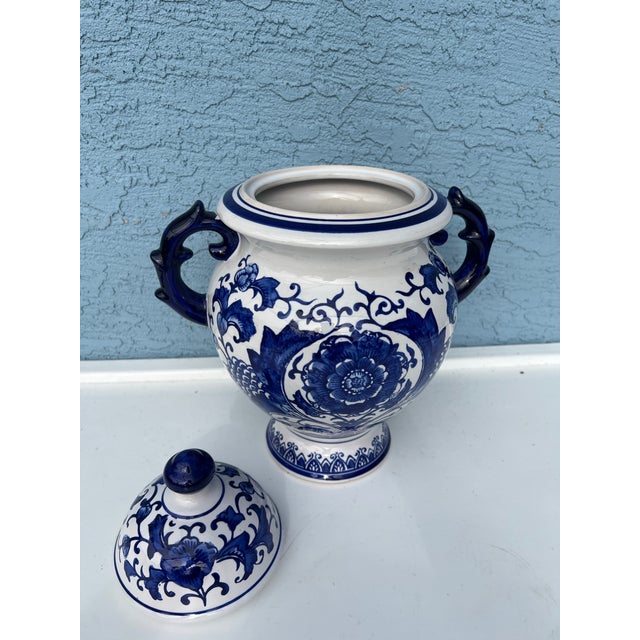 Ceramic Ginger Jar. Lidded Blue and White Jar. Features 2 Large handles. Measures 13" tall .