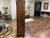 This antique oak bookcase features double doors with leaded glass panels adorned with tulips, standing on carved feet that...