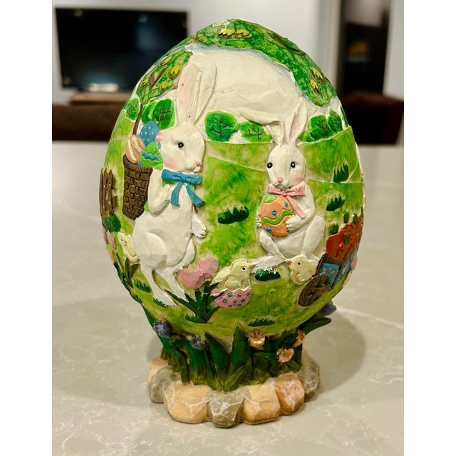 Incredibly detailed, hand painted Easter decor shows scenes of bunnies and chicks in a garden or park setting, under a...