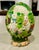 Incredibly detailed, hand painted Easter decor shows scenes of bunnies and chicks in a garden or park setting, under a...