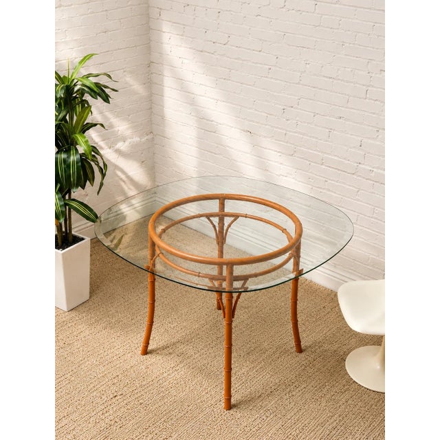 A wonderfully playful vintage dining table with a sculptural bamboo-style base finished in a bold burnt orange. The...