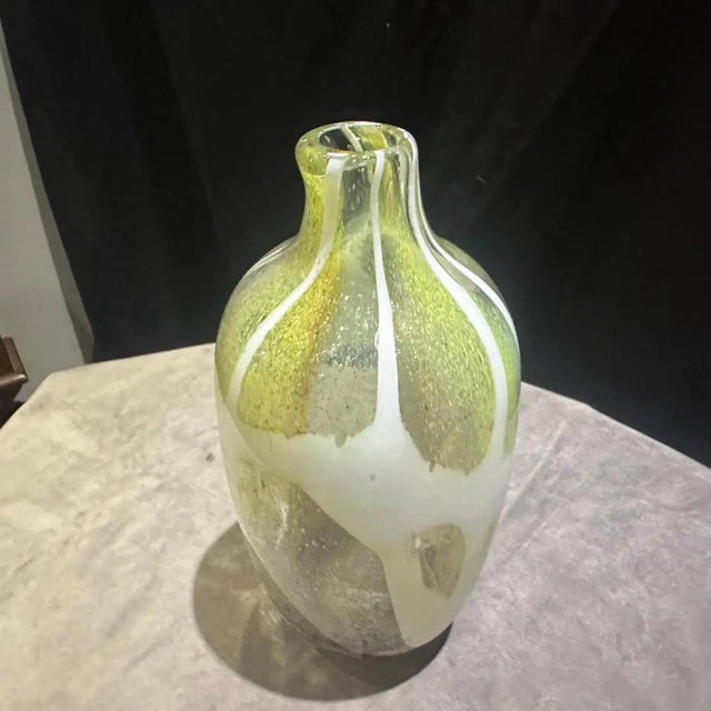 This vibrant 1980s Murano glass bottle vase is a striking example of late 20th-century Italian artistry, combining the...