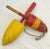 Weathered yellow and red painted wood buoys with carved identification numbers. Age wear, cracks, chipping paint. Smaller...