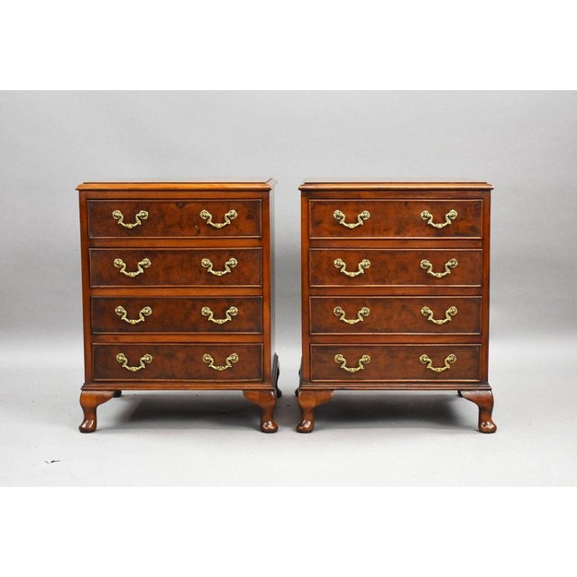 A well-matched pair of walnut bedside chests of drawers, dating from the mid 20th century and made in the traditional...