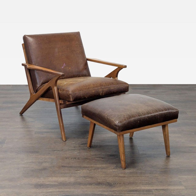 This Crate & Barrel lounge chair and ottoman set features a mid-century modern design with solid wood frames and rich...