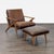 This Crate & Barrel lounge chair and ottoman set features a mid-century modern design with solid wood frames and rich...