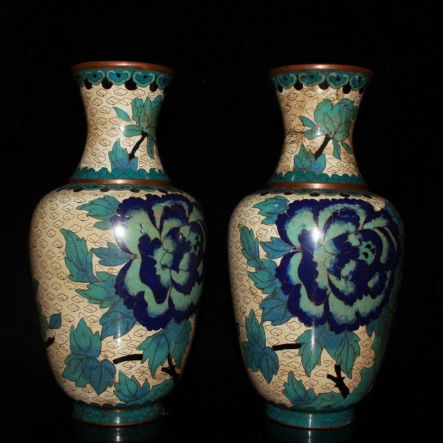 A beautiful pair of Chinese Cloisonné enamel vases. Each vase features a classic baluster shape with a flared rim and is...
