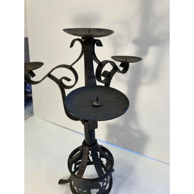 This hand forged iron candelabra features an elephant design on the base Each arm has incised designs hand done Nice patina