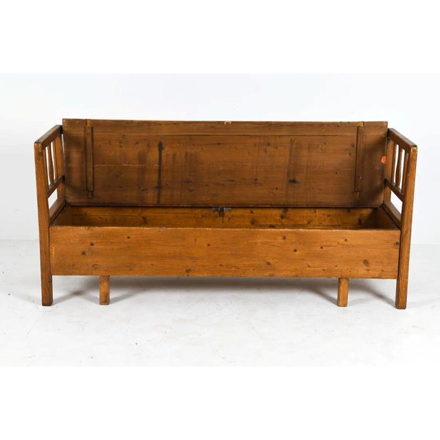 A 19th-century Swedish settle bench crafted from warm, solid pine, combining rustic simplicity with timeless Scandinavian...