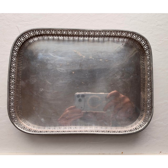 Vintage unmarked silver plated footed with pierced decoration heavy tray . 10.5"L X 7.75"H X 1.5"H in very good condition.