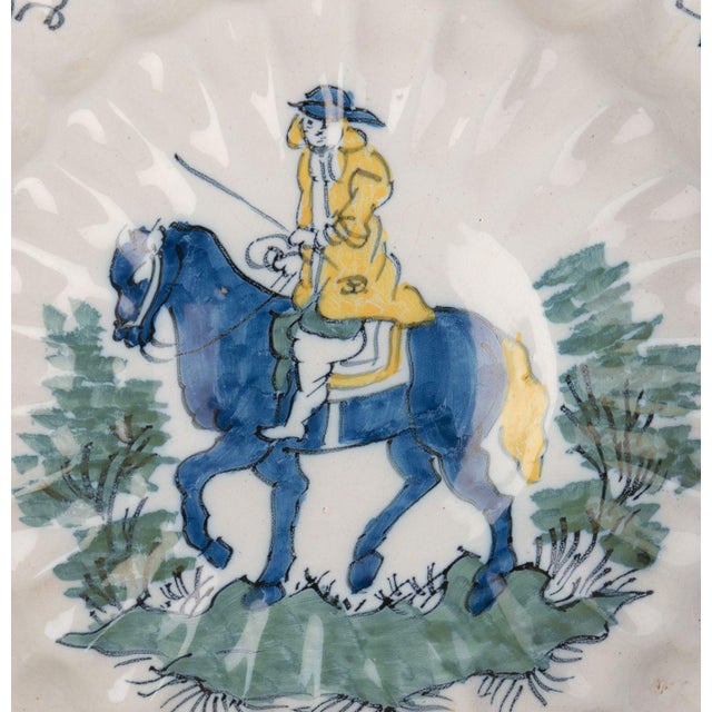 Polychrome lobed dish with horseman. Delft, 1690-1700. Dimensions: diameter 33,8 cm / 13 in. The lobed dish is composed of...