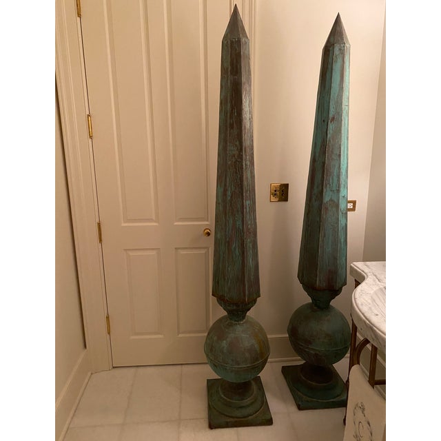 Striking pair of copper pillars...patina and weathered. Bottom of base is flaking due to exposure, but structurally sound.