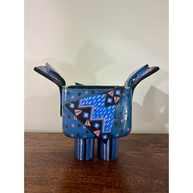 A striking handcrafted American studio ceramic vessel dating to the late 1980s or early 1990s, embracing the playful...