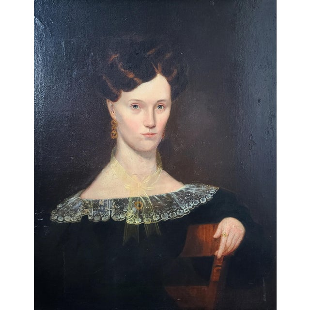 Original 19th century American portrait featuring a waist-length view of a stoic woman in a black dress with a lace...
