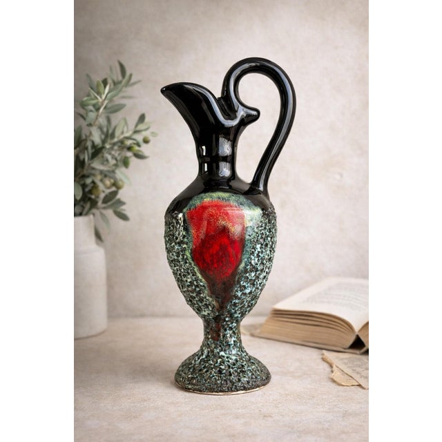 A highly expressive Italian mid-century ceramic ewer in the manner of Bitossi, showcasing a dramatic interplay of form,...