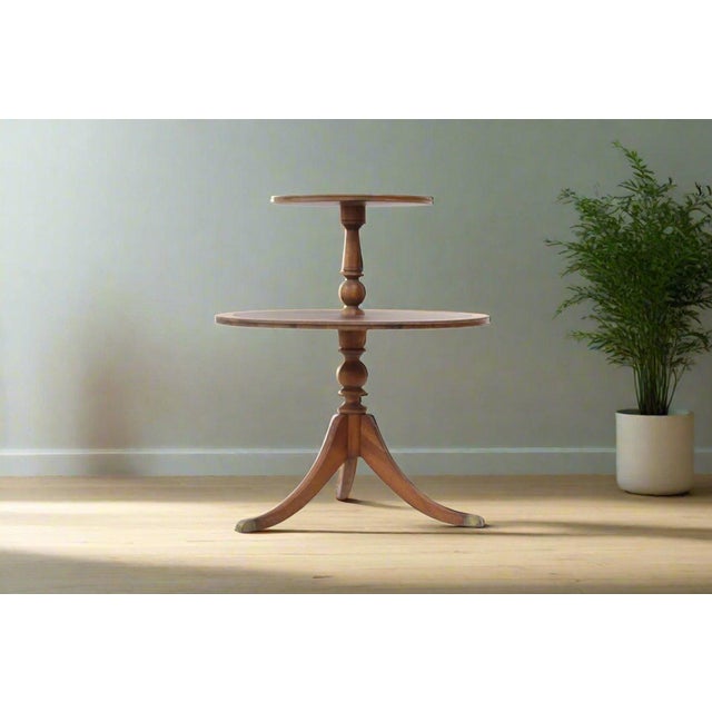 2-tier mahogany tripod side table with original leather top and nicely turned center column. Condition: Good, wear...