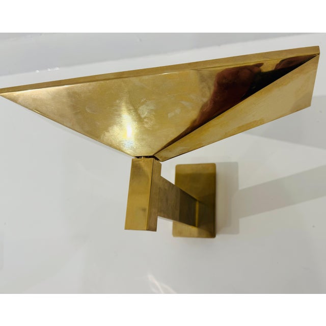 An original pair of French Post Modern gold plated steel modernist wall lamps designed by Pierre Disderot for Verre...