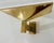 An original pair of French Post Modern gold plated steel modernist wall lamps designed by Pierre Disderot for Verre...