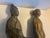 Decorative pair of vintage ceramic figures depicting traditional robed scholars or dignitaries in an Asian-inspired style....
