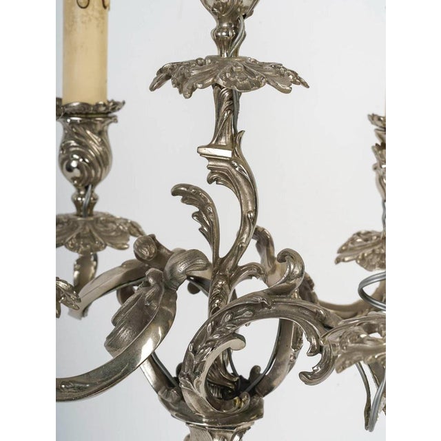Pair of Louis XV style silver plated bronze candelabra, 19th Century. A pair of Louis XV style silvered bronze...
