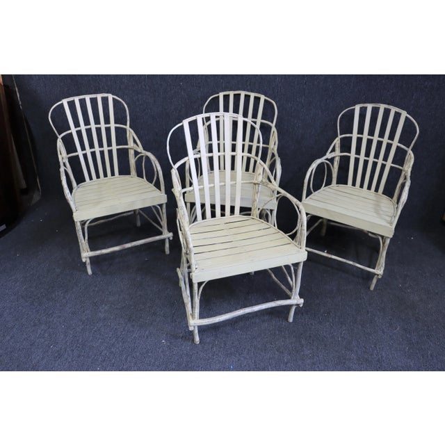 Set of 4 Adirondack style chairs . Made of bent wood tree limbs , wood slat seat , distressed cream painted finished