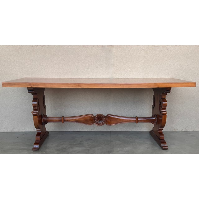 A monumental 20th century Spanish trestle table, having a rectangular framed solid walnut inset board top, resting on hand...