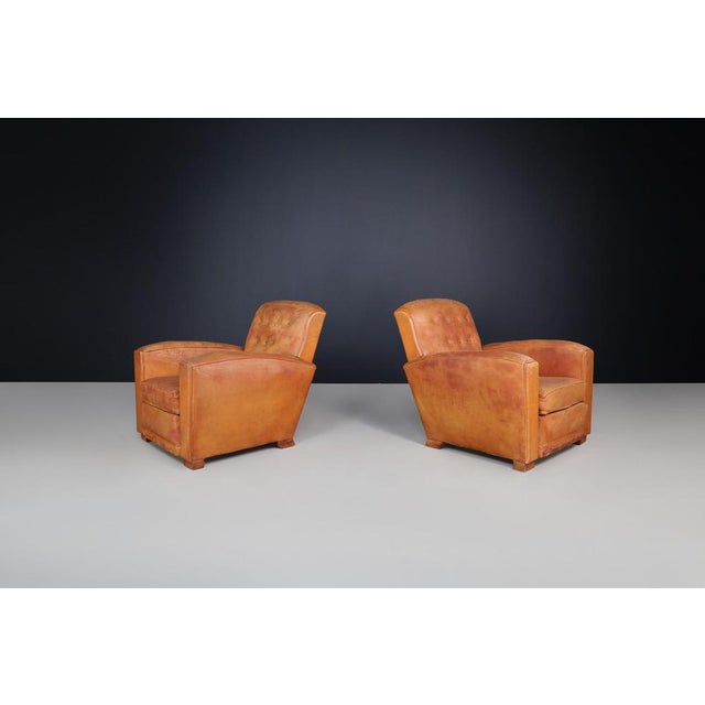 Art Deco Patinated Leather Lounge Chairs, France, 1940 A beautifully preserved example of French Art Deco design, this...