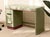 A charming vintage writing desk finished in soft mint green with warm wood-tone accent details. Its streamlined...