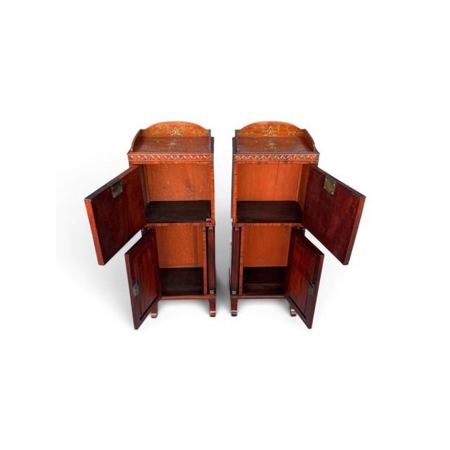 A finely decorated pair of English satinwood pedestal cabinets dating to circa 1900. Each tall, narrow cabinet is richly...
