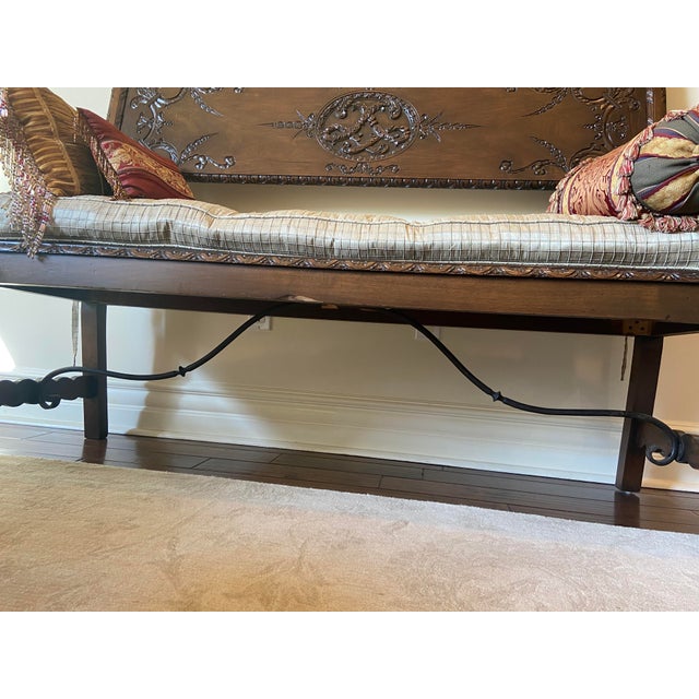 This is a 19th century dark colored hand carved bench from Spain with intricate wood carvings. Wood type unknown but...