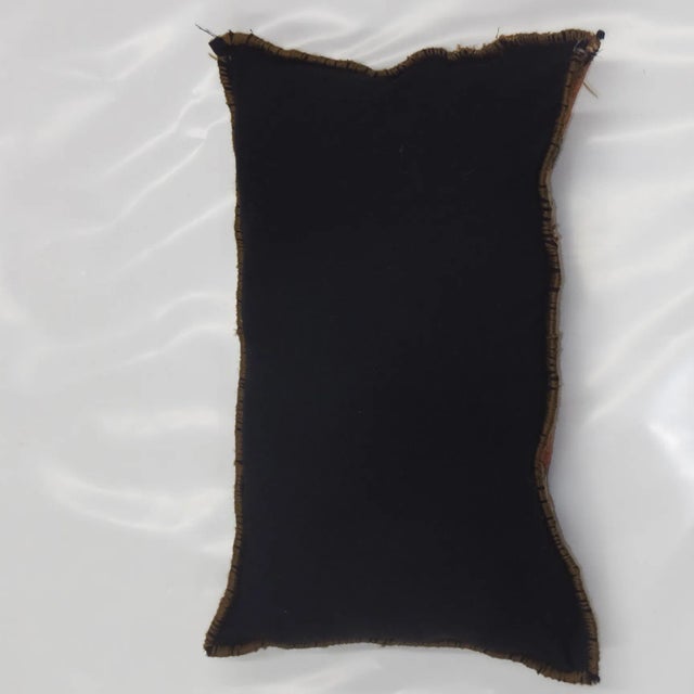 Pillow with wool pile genuine hand woven antique Persian rug fragment. Poly fill, fabric backing with sewn closure.