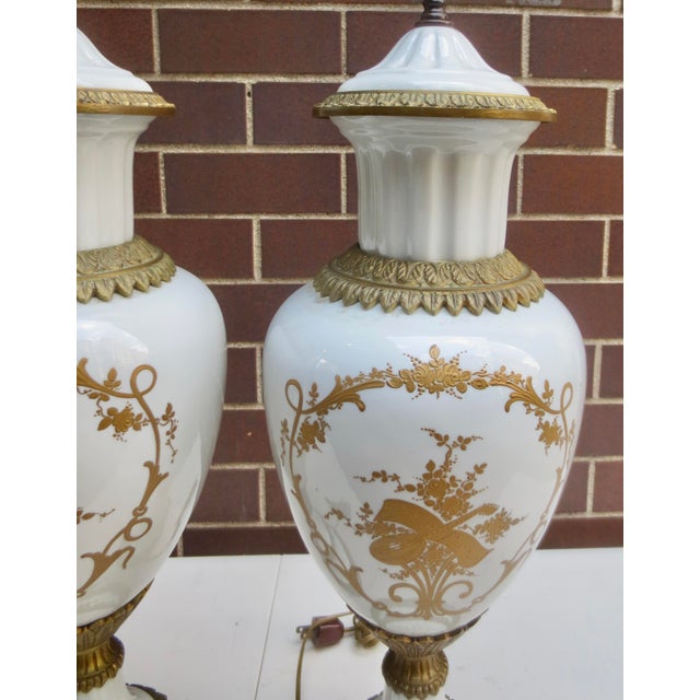 Matching pair of Sevres Porcelain and bronze-mounted table lamps. Gilt-bronze and hand-painted bodies on a pure white...