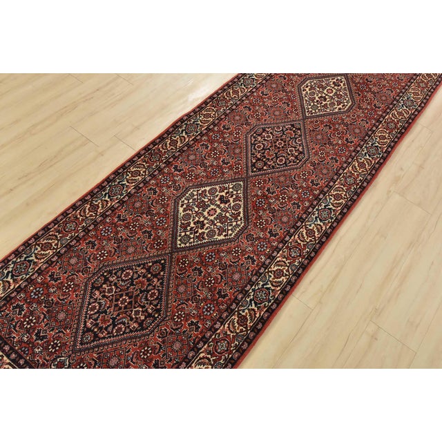 An authentic vintage traditional Bidjar rug hand-knotted with fine wool and natural dyes. This oriental rug features a row...